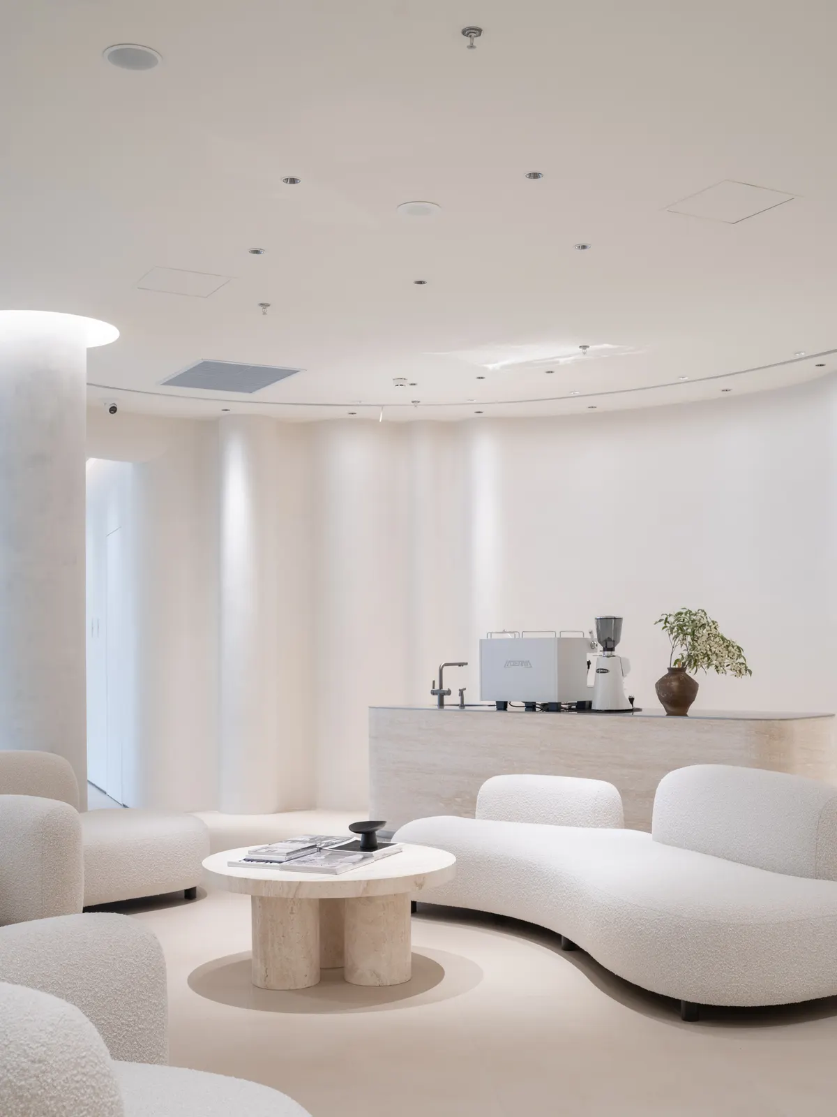 Curved coffee bar where clients wait with an espresso