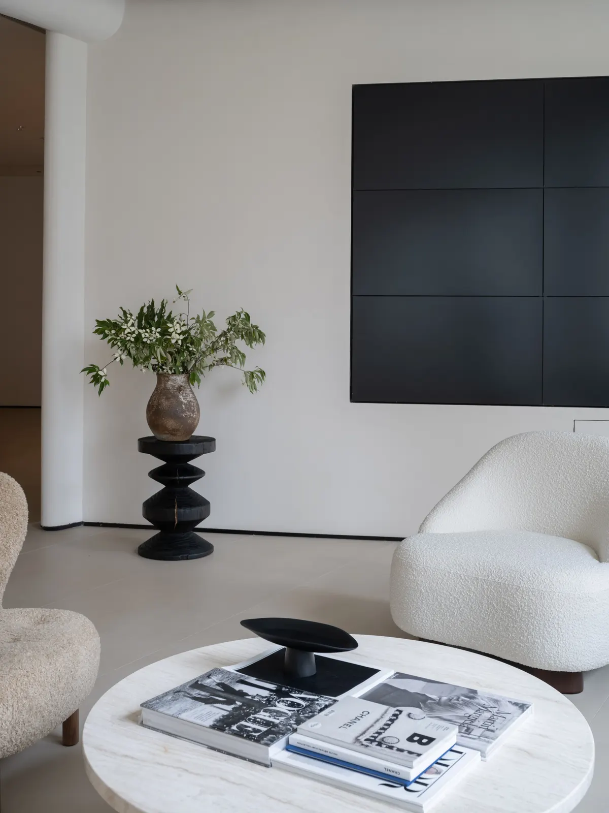 Gallery corner with sculptural vase and reading chair