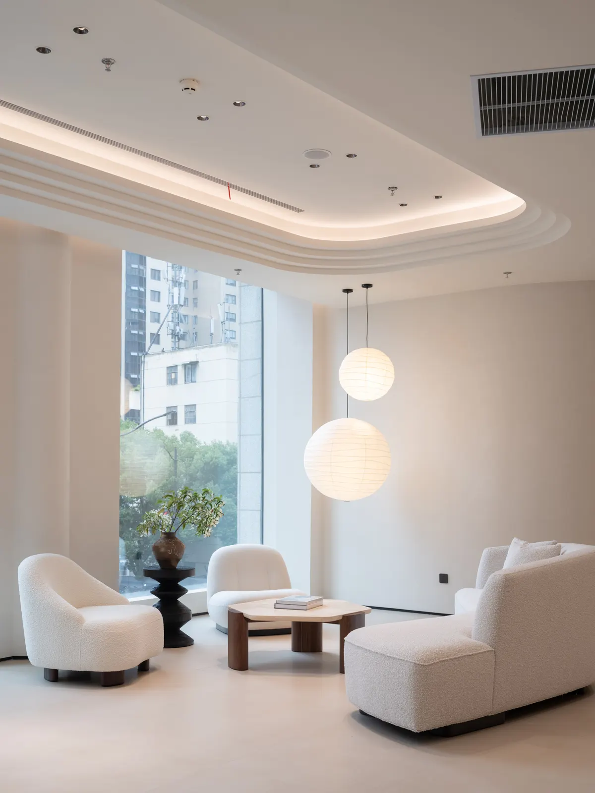 Window lounge with paper-globe lamps overlooking the city