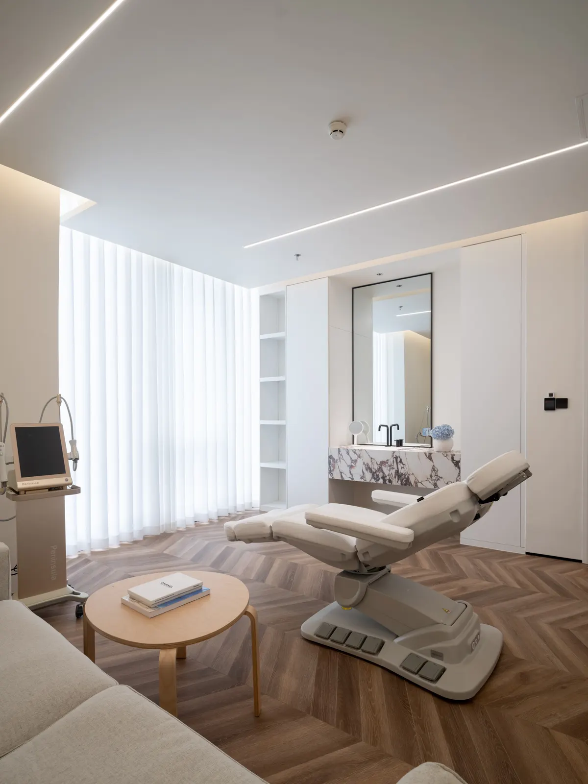 Private treatment room with reclining chair and marble basin
